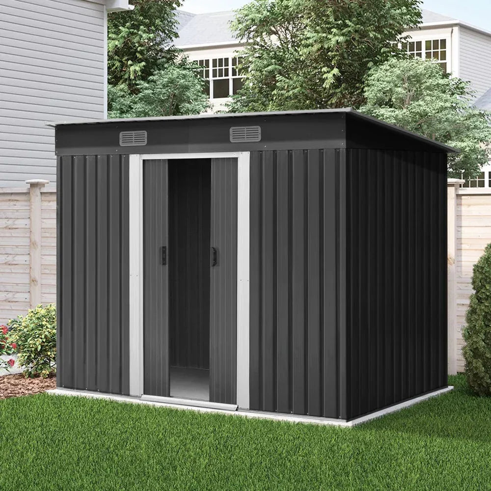 The entire garden shed assembled on flat outdoor ground with large double doors and vents.