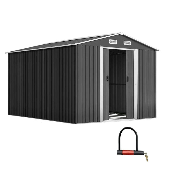 Front view of a large galvanized steel garden shed with double doors and a sloped roof in an outdoor setting.