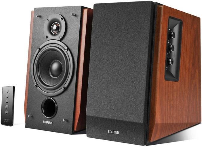 Brown EDIFIER bookshelf studio speakers with Bluetooth, displayed on a wooden surface with remote control.