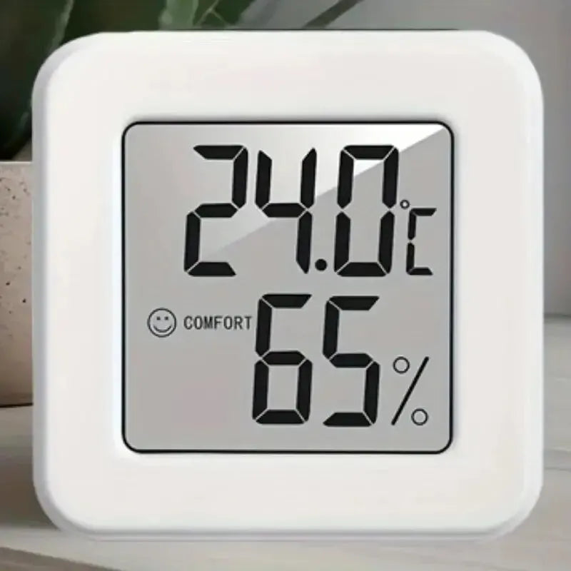 Compact indoor temperature and humidity meter showing digital display with temperature and humidity readings.