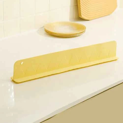 Flexible silicone sink splash guard with suction cups, designed to reduce water splashes along the sink edge.