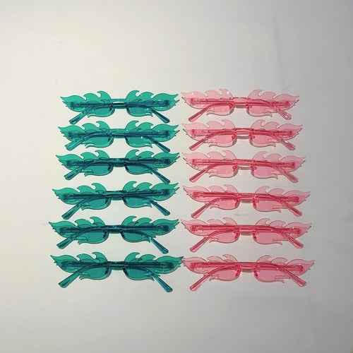 Twelve pairs of colorful flame-shaped sunglasses with gradient lenses arranged in rows on a white background.