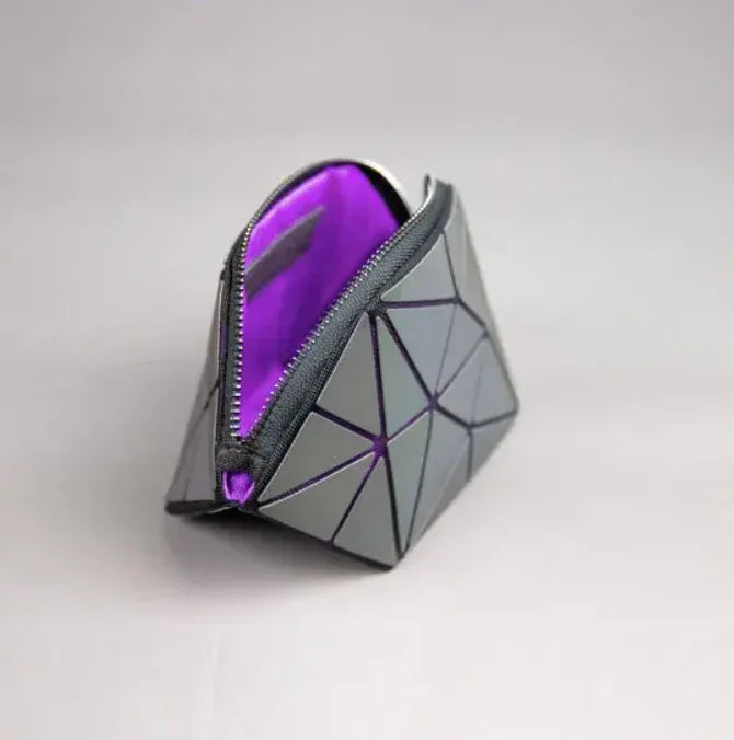 Close-up of the holographic surface texture of The Lumination Makeup Bag highlighting light reflections.