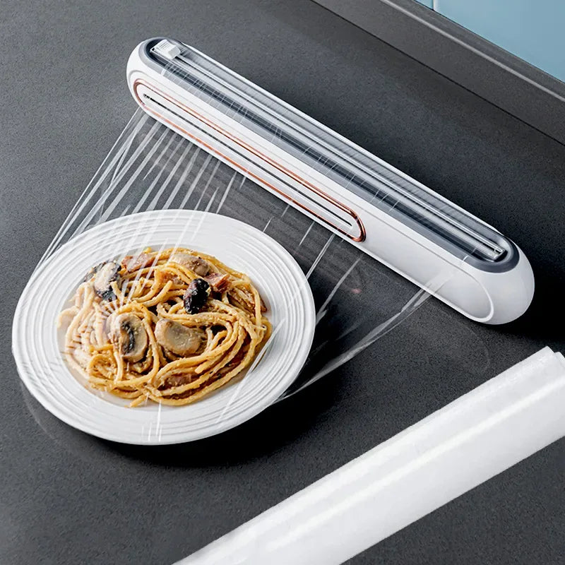 Magnetic plastic wrap dispenser with aluminum tin cutter on white background