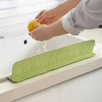 Flexible silicone sink splash guard with suction cups, designed to prevent water from splashing outside the sink.