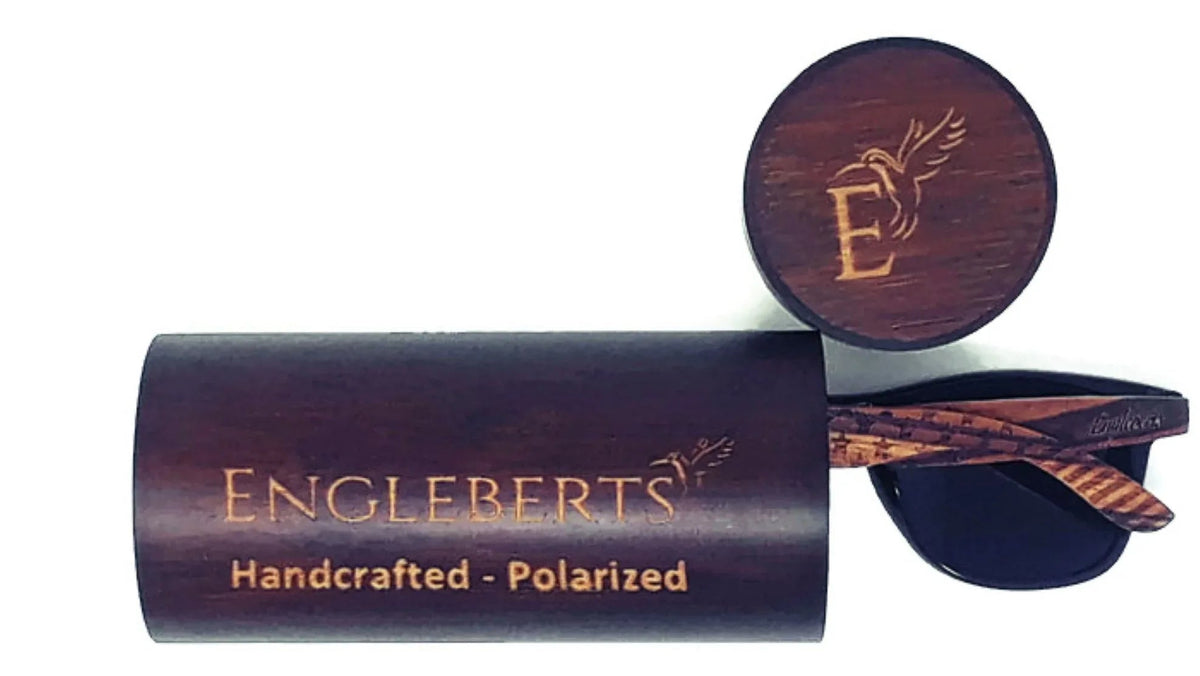 Close-up of engraved stars and bars design on the backside of wooden sunglass arms.