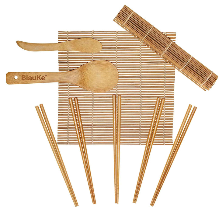 Complete bamboo sushi making kit including rolling mats, chopsticks, rice paddle, and spreader on a wooden surface.