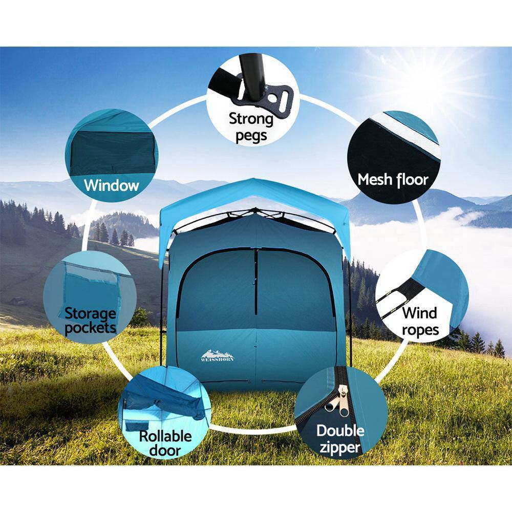 Weisshorn portable outdoor shower tent anchored firmly with ropes and pegs on a grassy campsite.