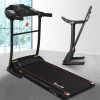 Electric treadmill positioned in a bright room with fitness accessories nearby.