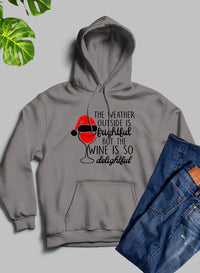 Black hoodie folded neatly showing winter graphic and branded text across chest.