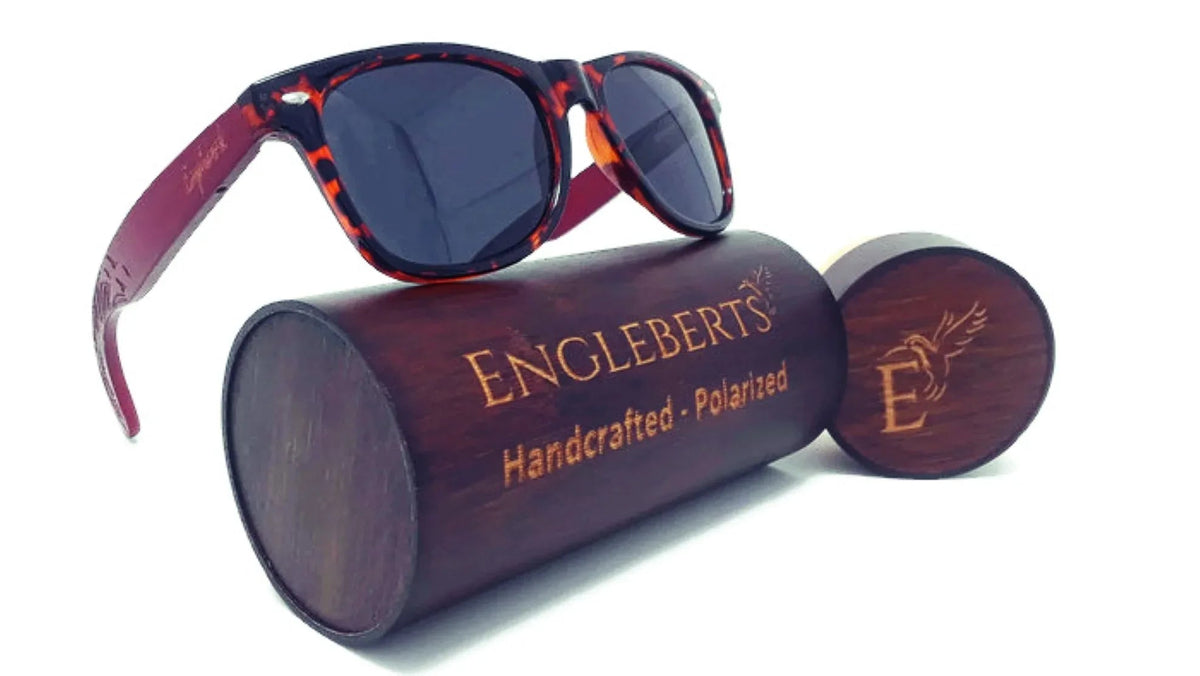Bamboo tortoise sunglasses displayed inside the engraved wooden case with cloth pouch.