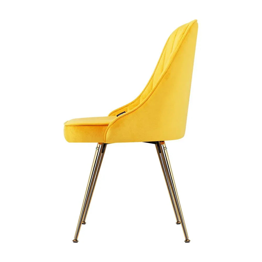 Gold splayed metal legs of Artiss dining chair standing on wooden floor highlighting stability.