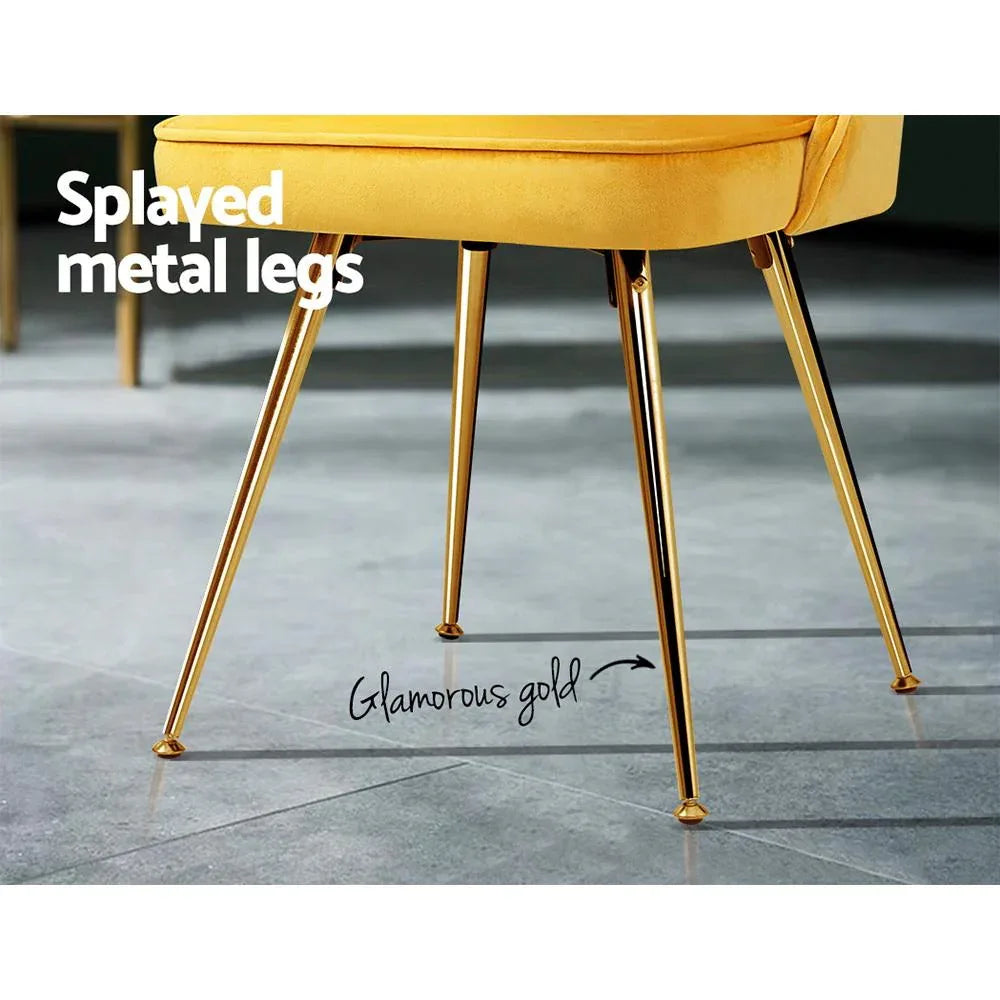 Close-up on scalloped velvet backrest hugging the chair frame with gold metal legs visible.