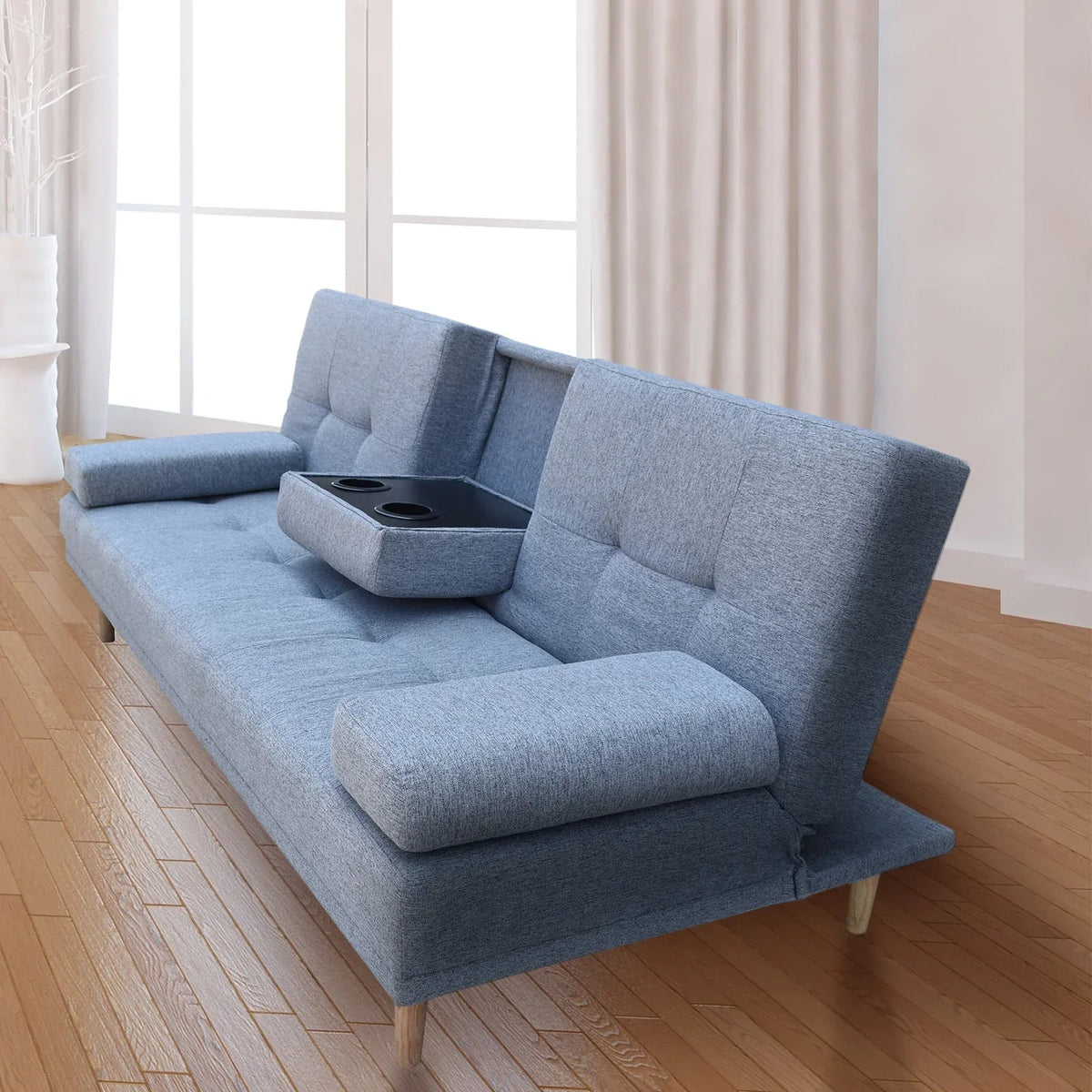 Modern living room featuring a grey 2-in-1 sofa bed with cupholder and removable cushions.