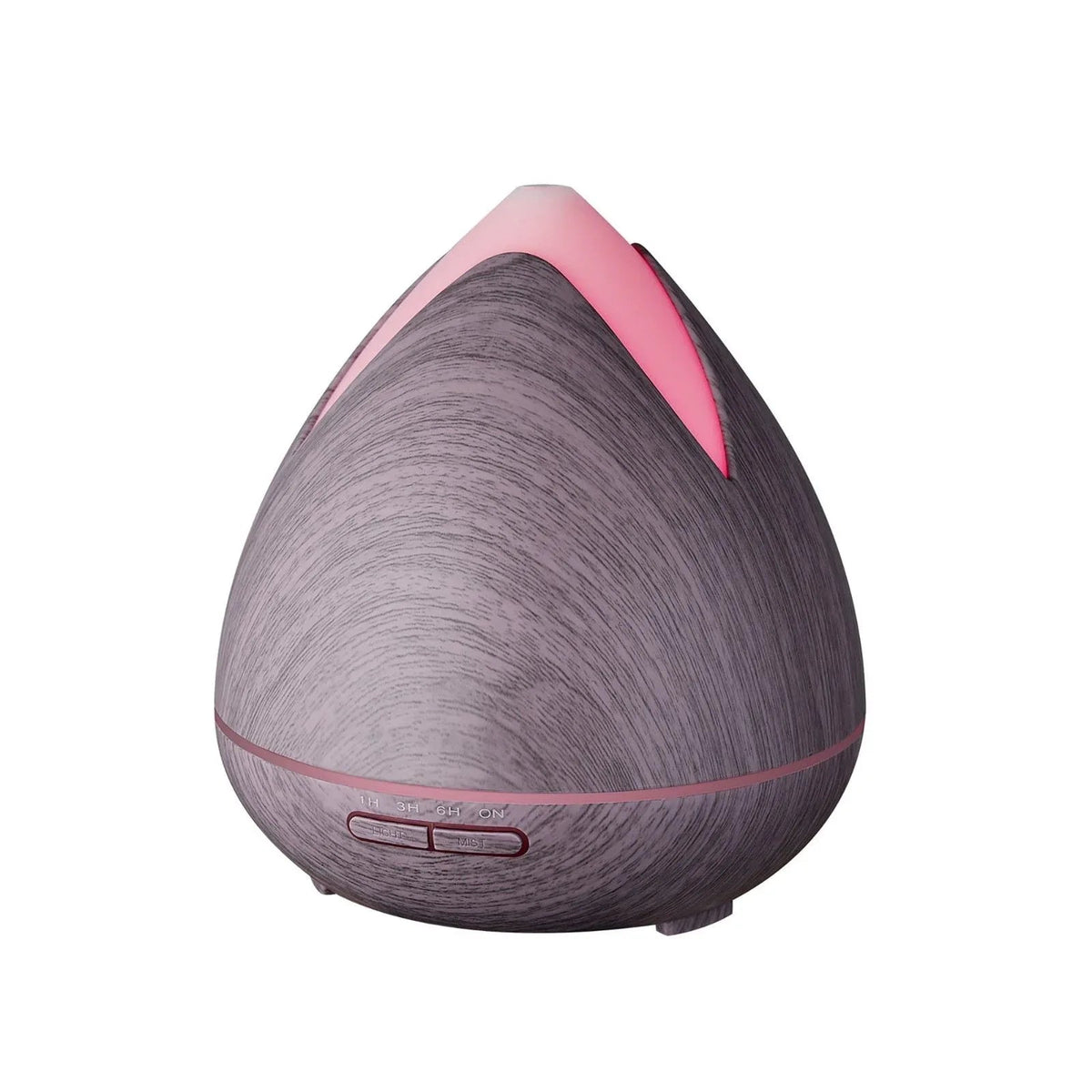 White ultrasonic aromatherapy diffuser emitting cool mist on wooden surface with eucalyptus leaves nearby.