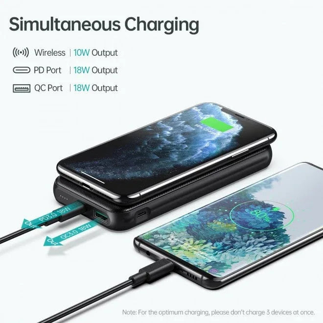 Hands holding the compact black wireless power bank, showing its slim design.