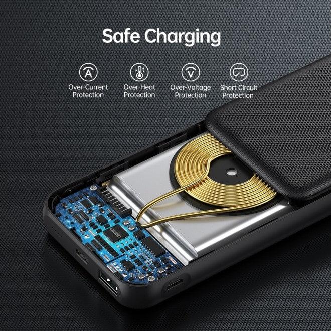 Black wireless power bank next to a charging cable and smartphone on a table.