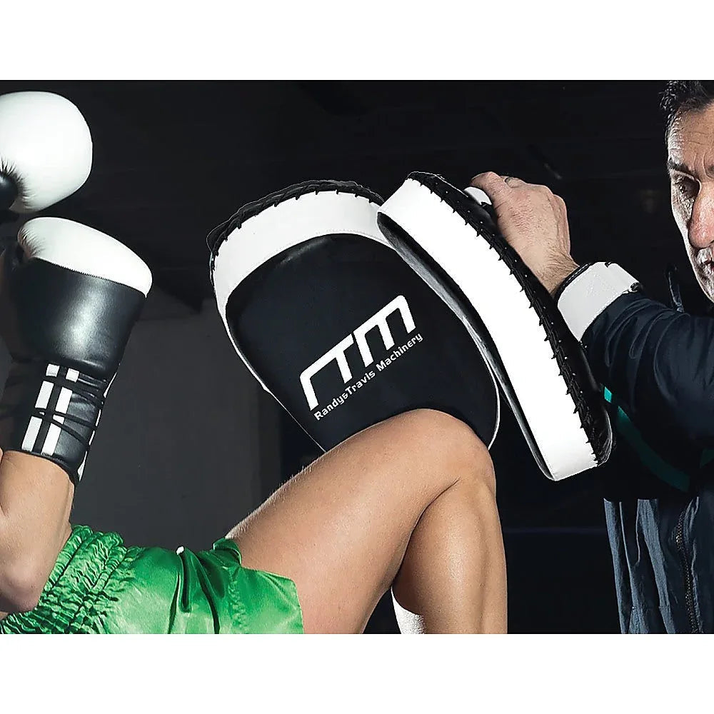 Close-up of hand holding padded curved strike shield for boxing training