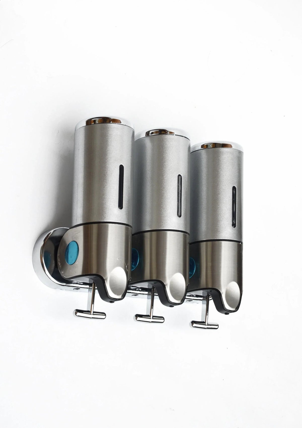 Stainless steel wall-mounted shower dispenser with three clear liquid containers and pump nozzles.