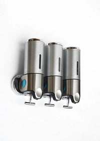 Stainless steel wall-mounted shower dispenser with three clear liquid containers and pump nozzles.