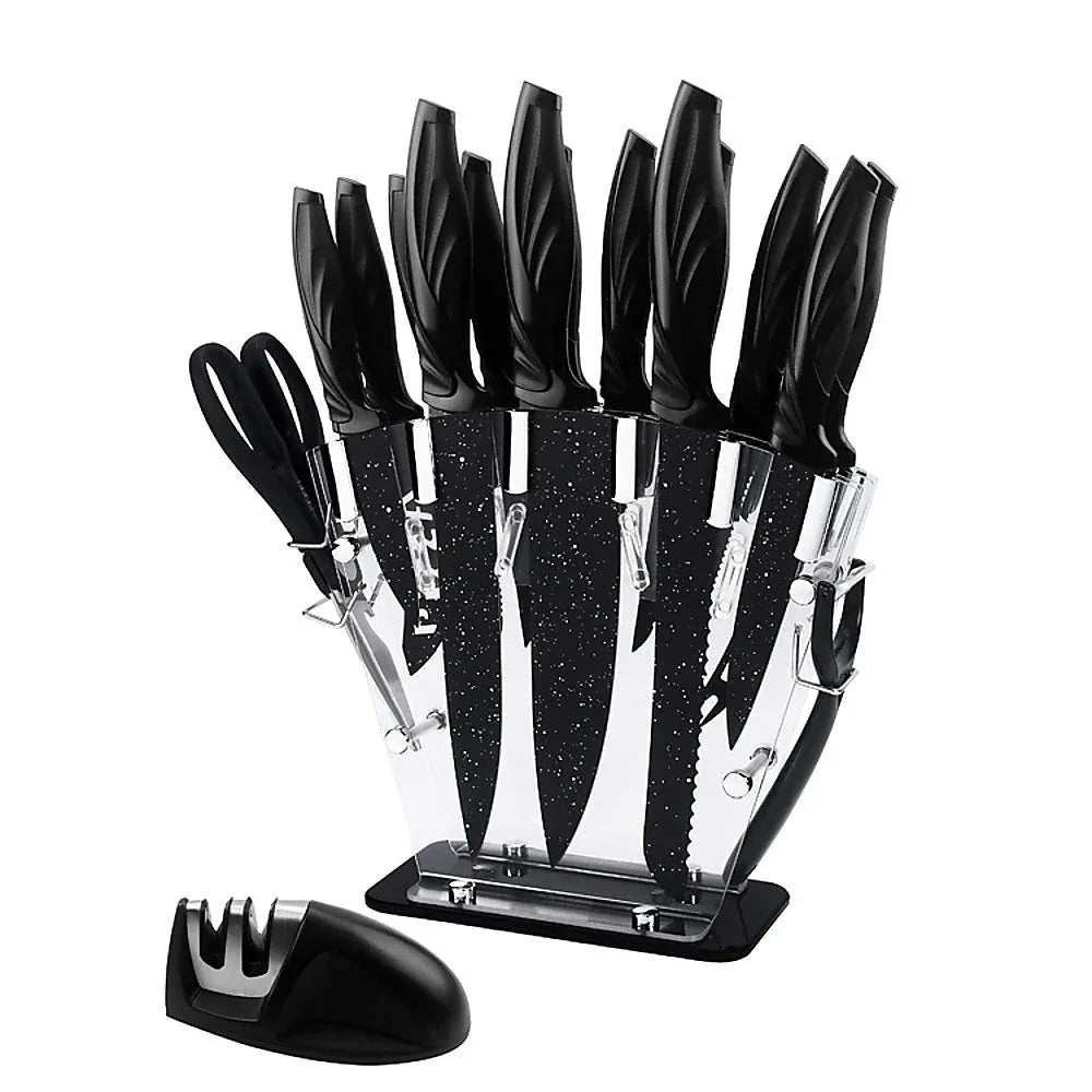 Close-up of stainless steel kitchen knives including chef, bread, and steak knives arranged on white.