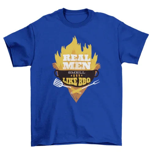 Man wearing black 'Real Men' BBQ graphic T-shirt, standing against a neutral background.
