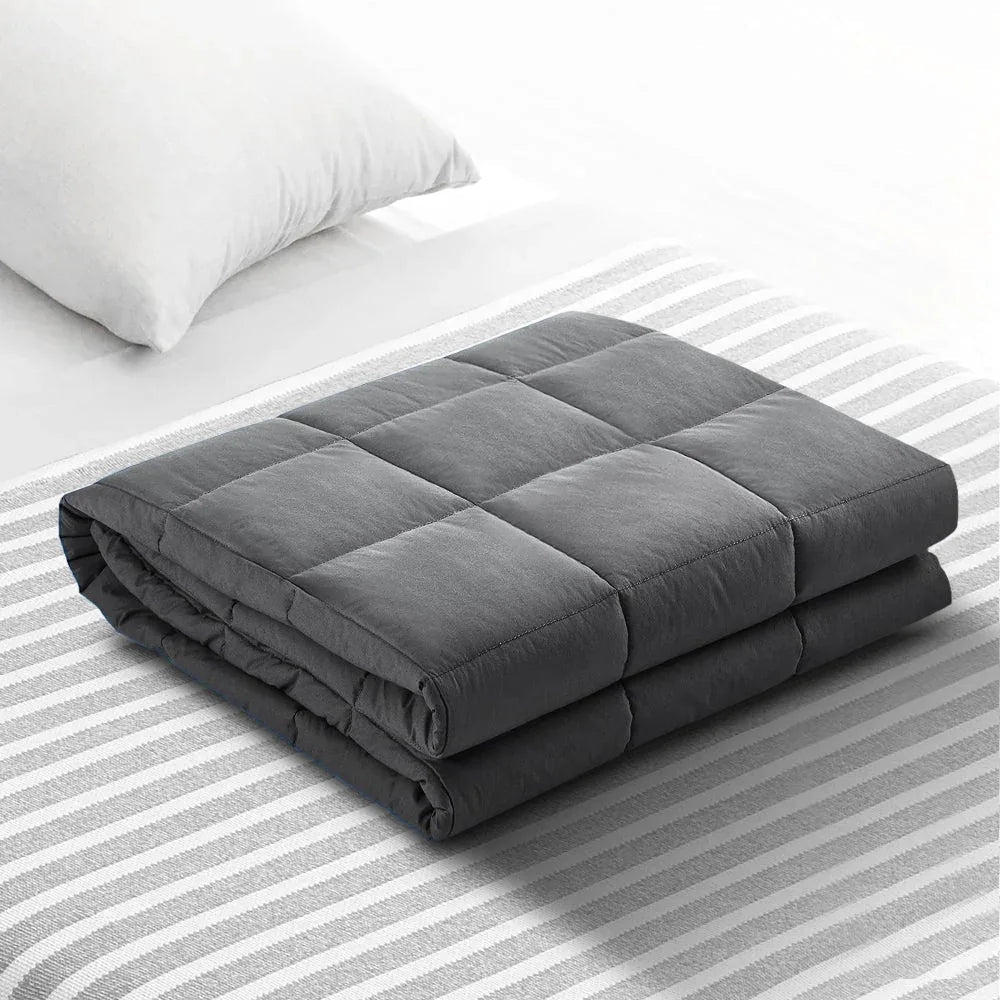 Weighted blanket rolled neatly placed on a shelf for storage demonstration.