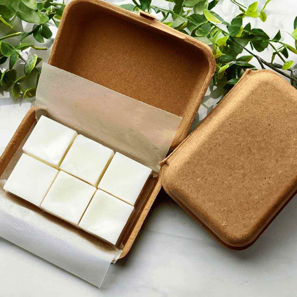 Wrapped package of dewy schnozberry wax melt tarts with natural coconut wax cubes inside