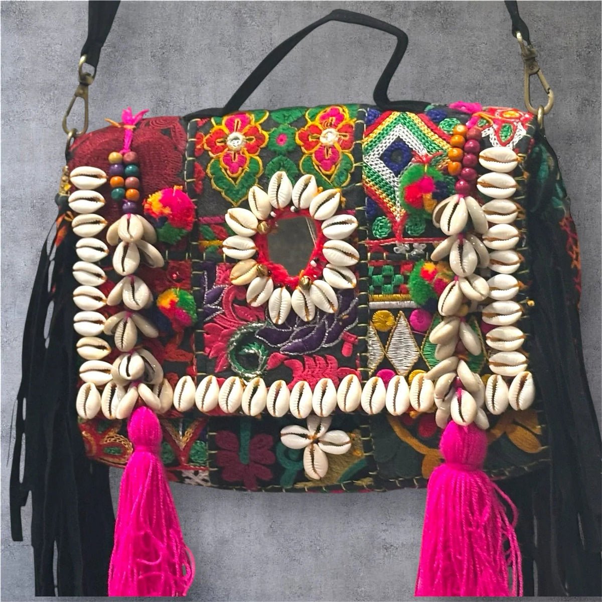 Banjara Boho Sling Bag angled side showing colorful tribal embroidery and shell decorations.