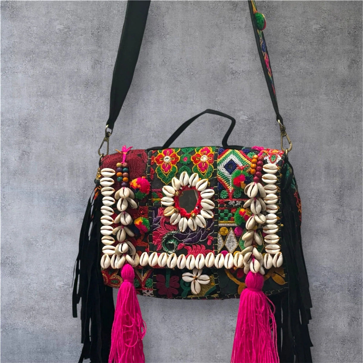 Banjara Boho Sling Bag full view showing intricate hand-embroidered multicolor patchwork and pom-poms.
