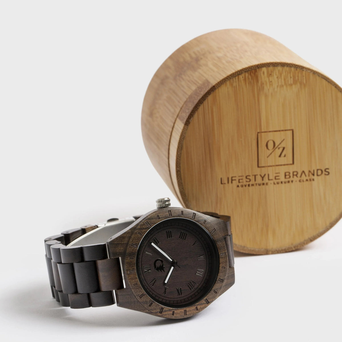 Men's wood watch lying flat with visible black walnut wooden face and silver watch hands.