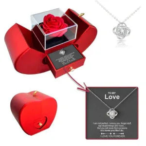 Side view of red apple jewelry box with artificial rose and a small drawer.