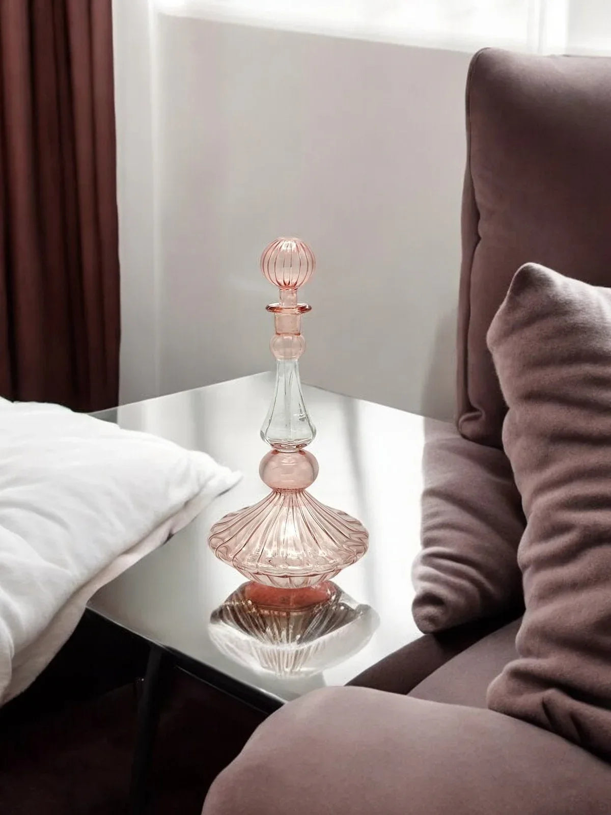 Handcrafted hand blown glass perfume bottle with delicate hand painted floral design on clear glass.