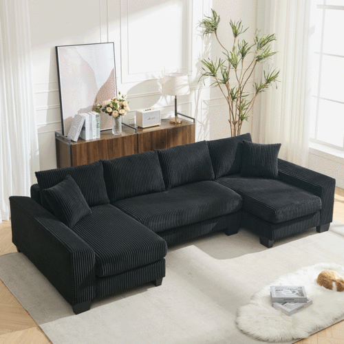 Large U-shaped black corduroy sleeper sofa with square arms and pull-out convertible bed in a modern living room.