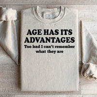 Peach sweatshirt displayed flat with prominent white "Age Has Its Advantages" lettering.