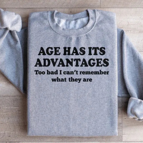 Peach sweatshirt with large white "Age Has Its Advantages" text across the front.