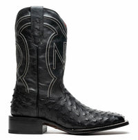 Front angled view of black cowboy boot with ostrich skin on vamp and square toe.