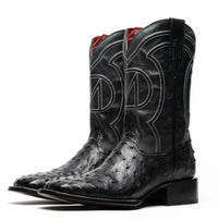 Side view of premium black ostrich skin cowboy boot highlighting red leather interior.