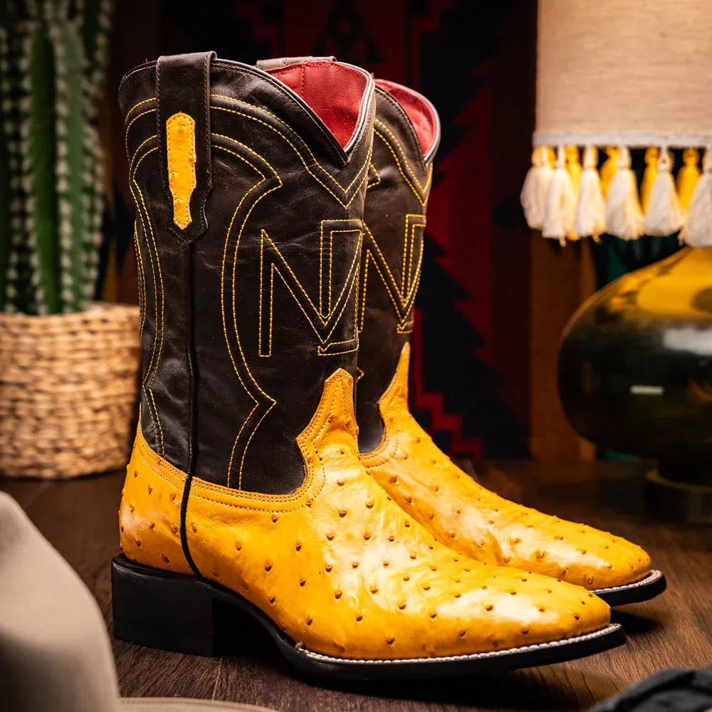 Lifestyle image of Alabama Buttercup boot worn outdoors on rustic wooden floor.