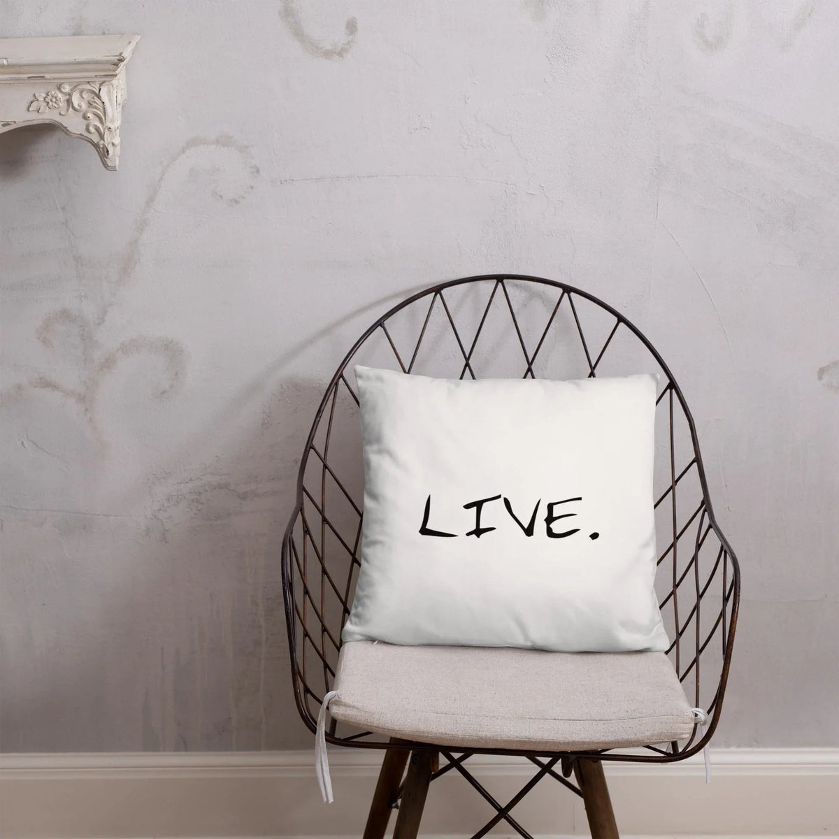 White pillow placed on dark sofa with light walls in a cozy living room