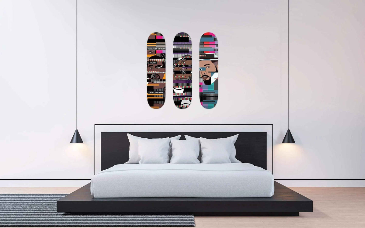 Bedroom interior featuring Drake Skateboard displayed above bed with pillows and cozy bedding.