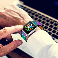 The Lumination Holographic Apple Watch Band attached to an Apple Watch displaying a glowing, holographic effect.
