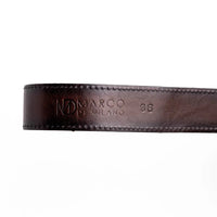 Detailed view of antique brass western buckle attached to natural python skin belt.
