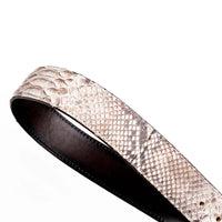 Flat lay of Arkansas python skin belt displaying full length and textured pattern on neutral surface.