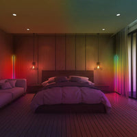 Close-up of RGB LED corner floor lamp glowing with vibrant multi-color lighting effects.