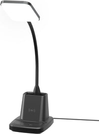 Desk scene showing LED lamp, wireless charging phone, and workspace essentials.