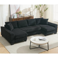 Large black U-shaped sleeper sofa with corduroy upholstery, pull-out bed, and plush seating for four.