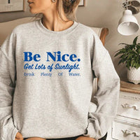 Sport grey sweatshirt with bright, cheerful motivational text across the front