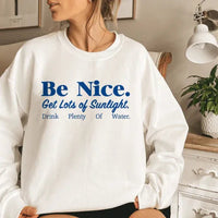 White sweatshirt displaying colorful inspirational message promoting kindness and wellness