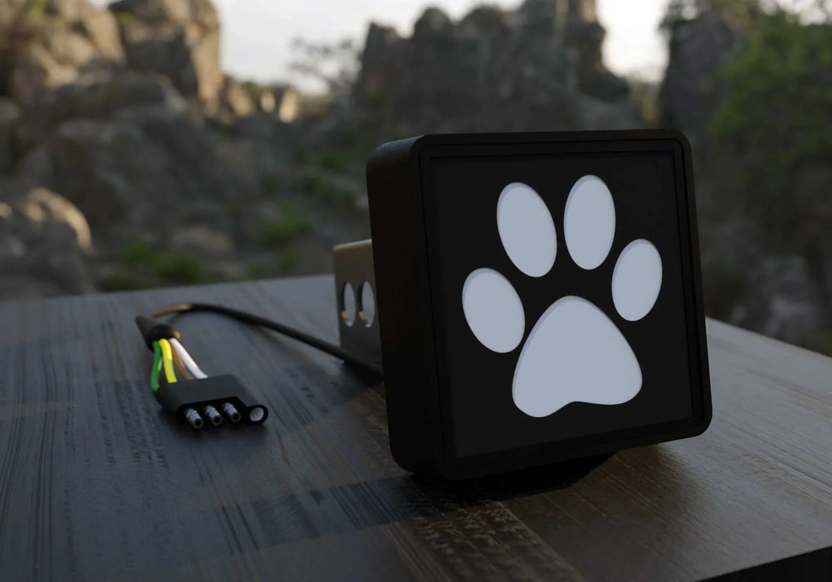 Paw Print LED Hitch Cover displayed against a black background showing LED detailing